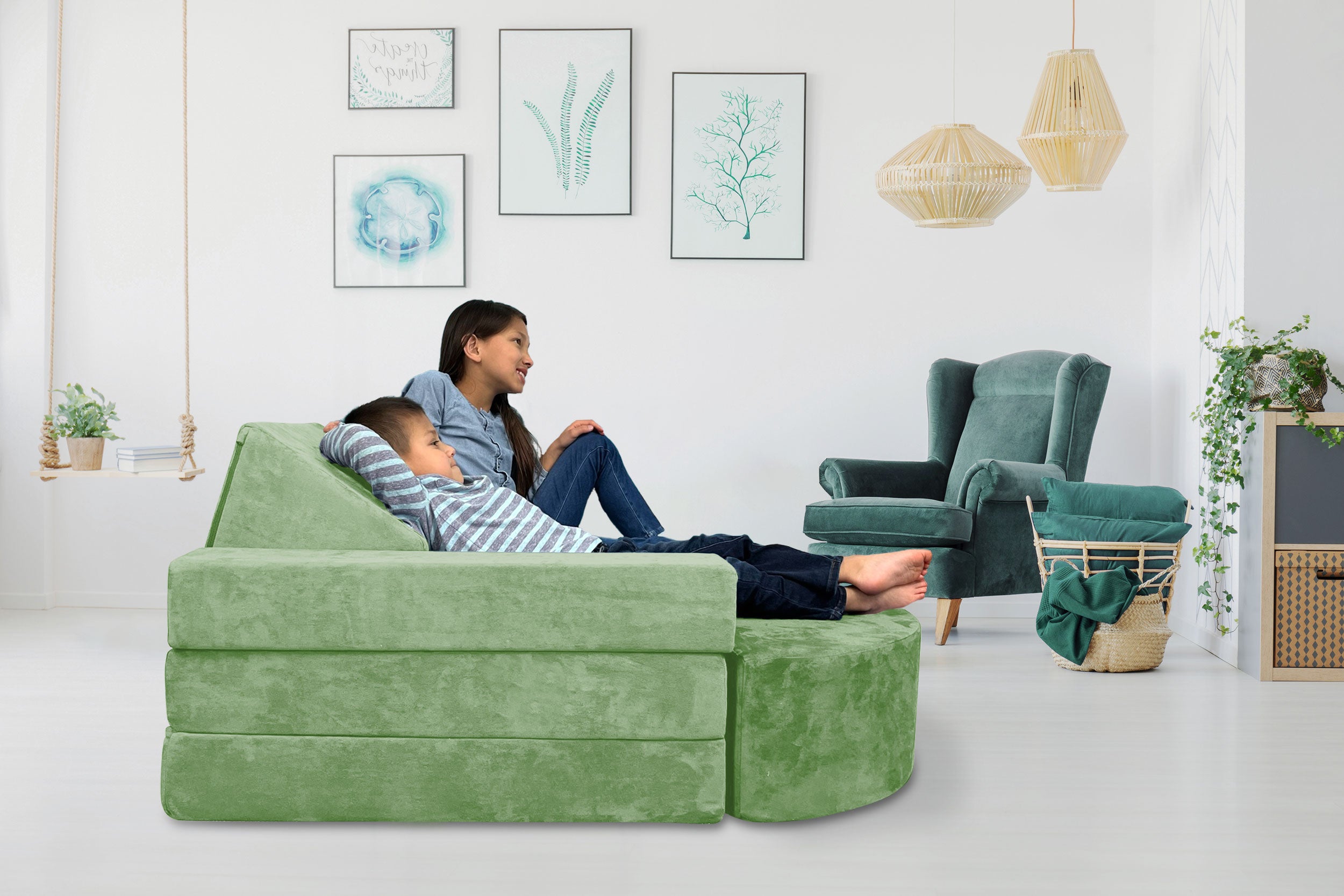 Smiling kids relaxing on green Mod Blox microsuede couch cover set in a modern living room.